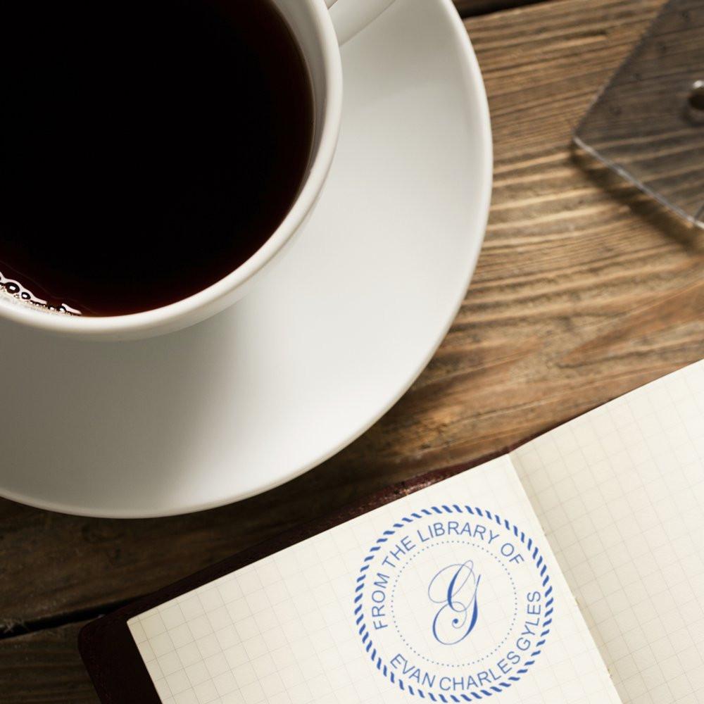 Custom library rubber stamp impression in a notebook, personalized From the Library Of bookplate for collectors.