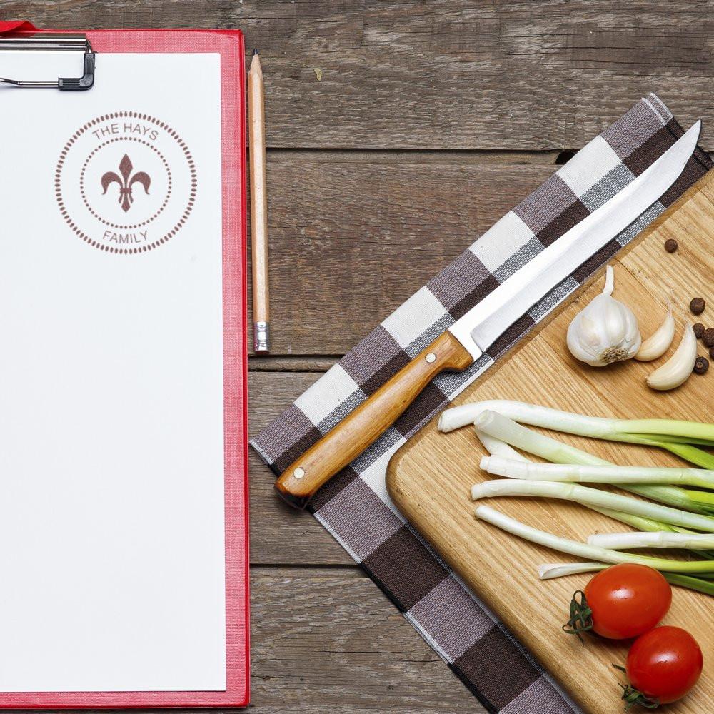 The Hays Family custom rubber stamp on recipe clipboard with rustic kitchen ingredients, ideal for personalized home branding.