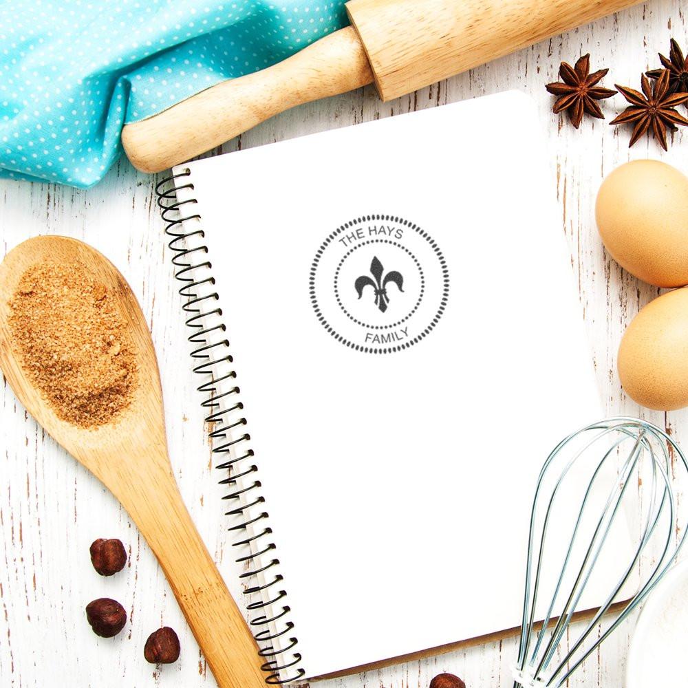 Custom family rubber stamp on notebook for personalized baking branding and kitchen stationery