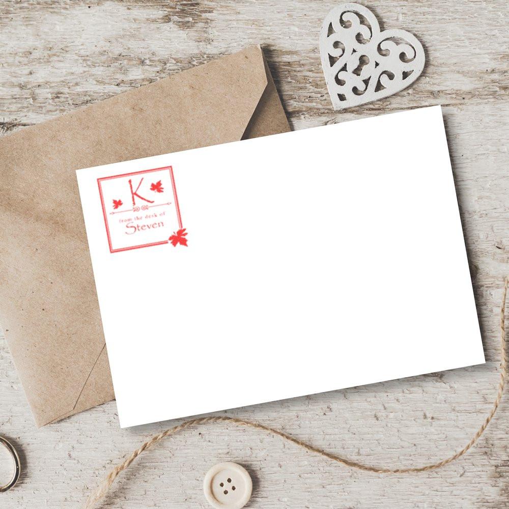 Custom rubber stamp impression on blank stationery with envelope, featuring a personalized monogram and name design.