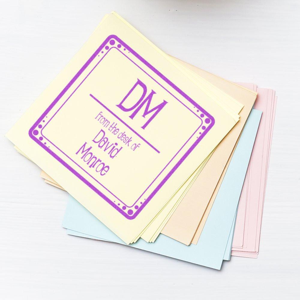 Custom rubber stamp reading From the desk of David Morroe on pastel note cards for personalized office stationery.