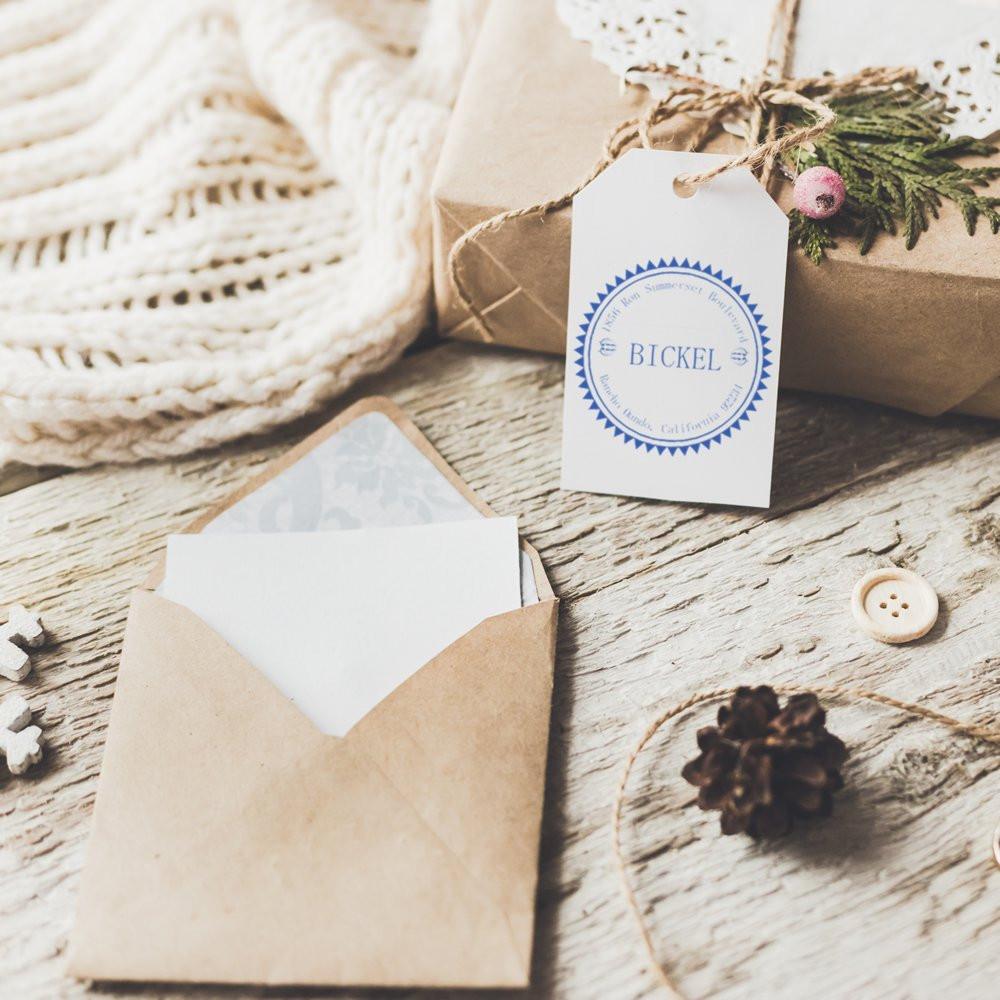 Custom rubber stamp on gift tag and envelope for personalized wedding stationery and packaging branding