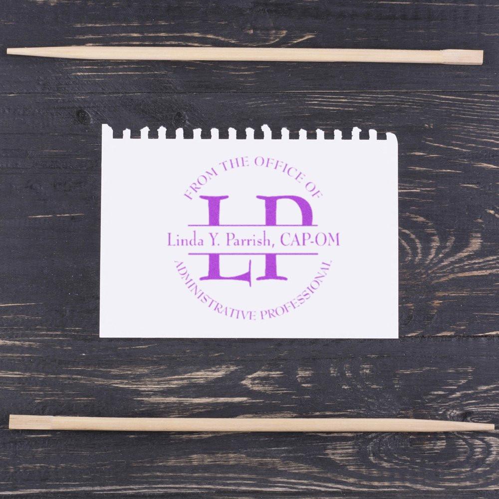 Custom rubber stamp impression for an administrative professional, featuring monogram and name on paper with wooden handles.