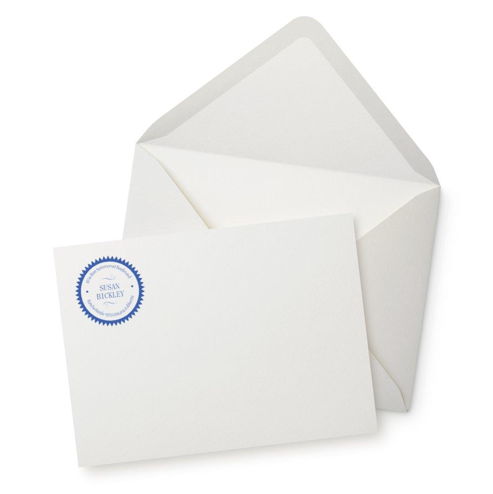 White envelope and stationery card with a blue custom rubber stamp seal for business branding and correspondence.