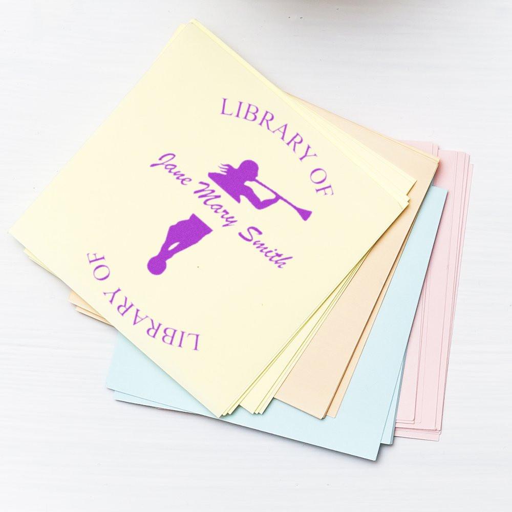 Stack of pastel library-themed book covers and stationery cards reading LIBRARY OF LOVE with purple silhouette, gift set