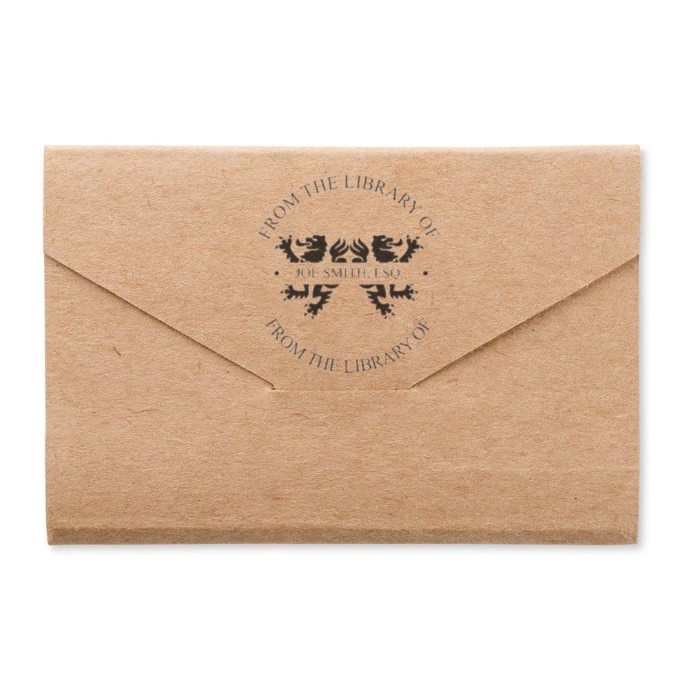 Kraft envelope with custom From the Library Of rubber stamp for personalized bookplate and book ownership.
