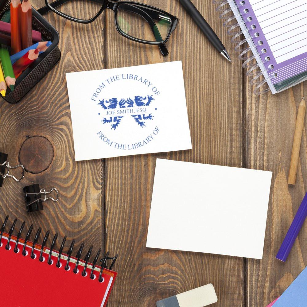 Custom library rubber stamp imprint on paper with desk stationery, showing a personalized bookplate for Joe Smith, Esq.