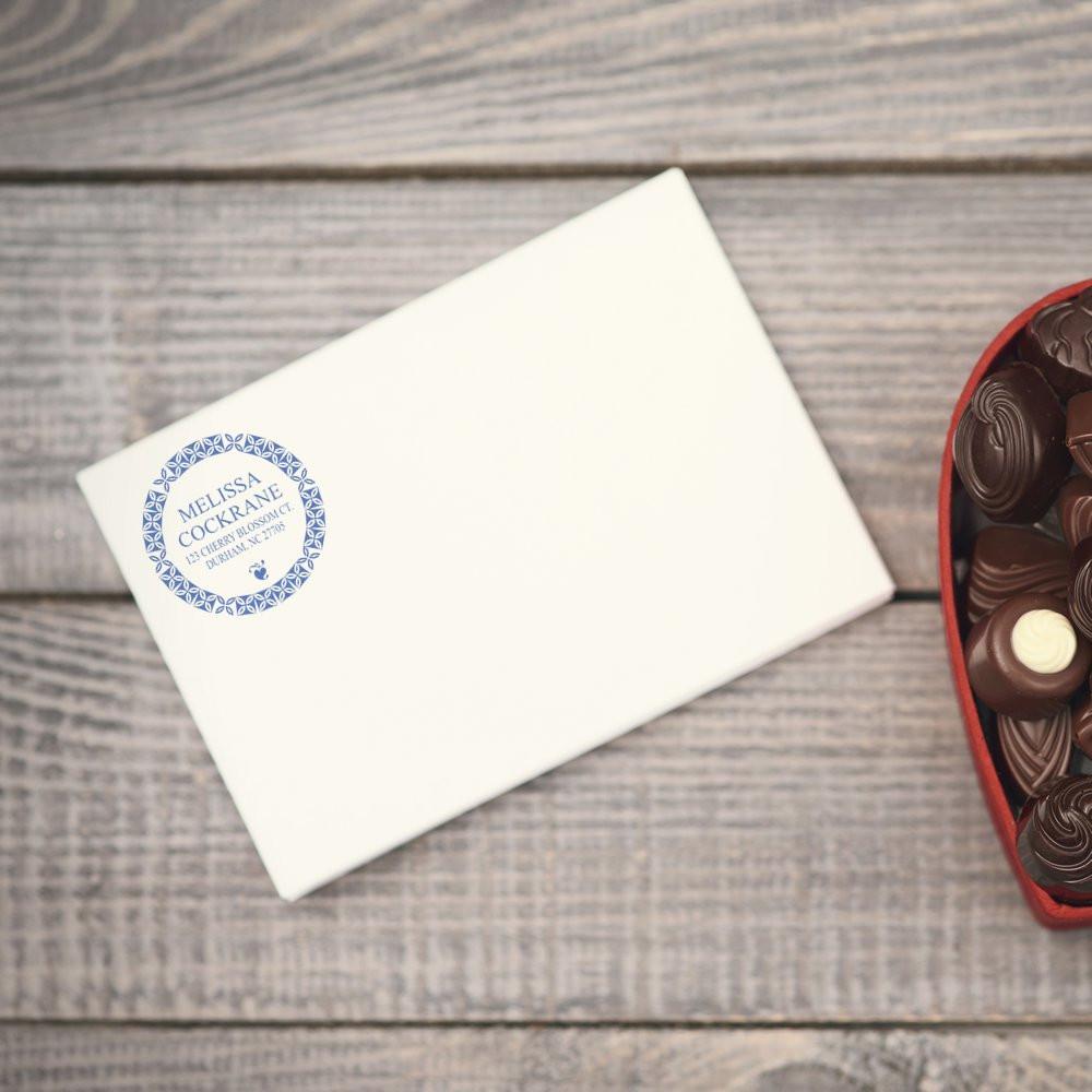 Personalized round return address rubber stamp on white envelope for wedding invitations and mailing.