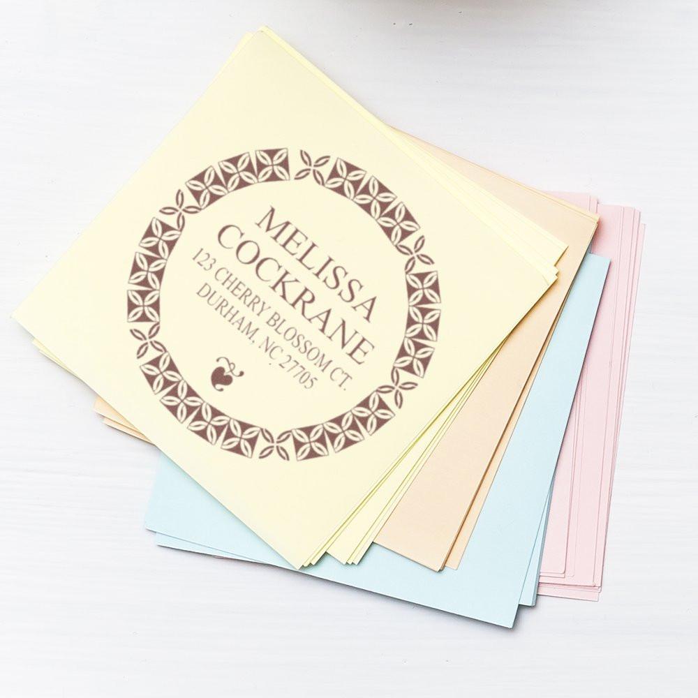 Custom return address rubber stamp on pastel stationery cards with floral border, perfect for envelopes and mailings.