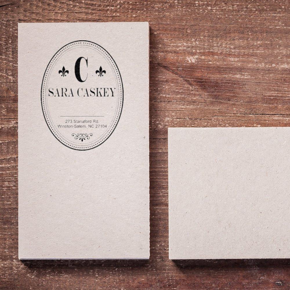 Custom monogram rubber address stamp on stationery for personalized return address labeling.