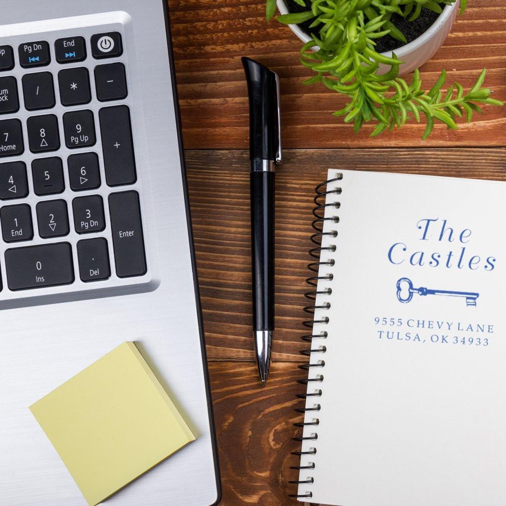 Custom return address rubber stamp impression on notebook, ideal for personalized stationery and business branding.
