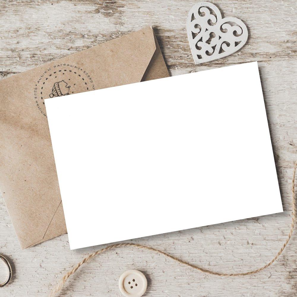 Blank greeting card with kraft envelope and decorative rubber stamp on rustic wood, ideal for custom stamp branding.