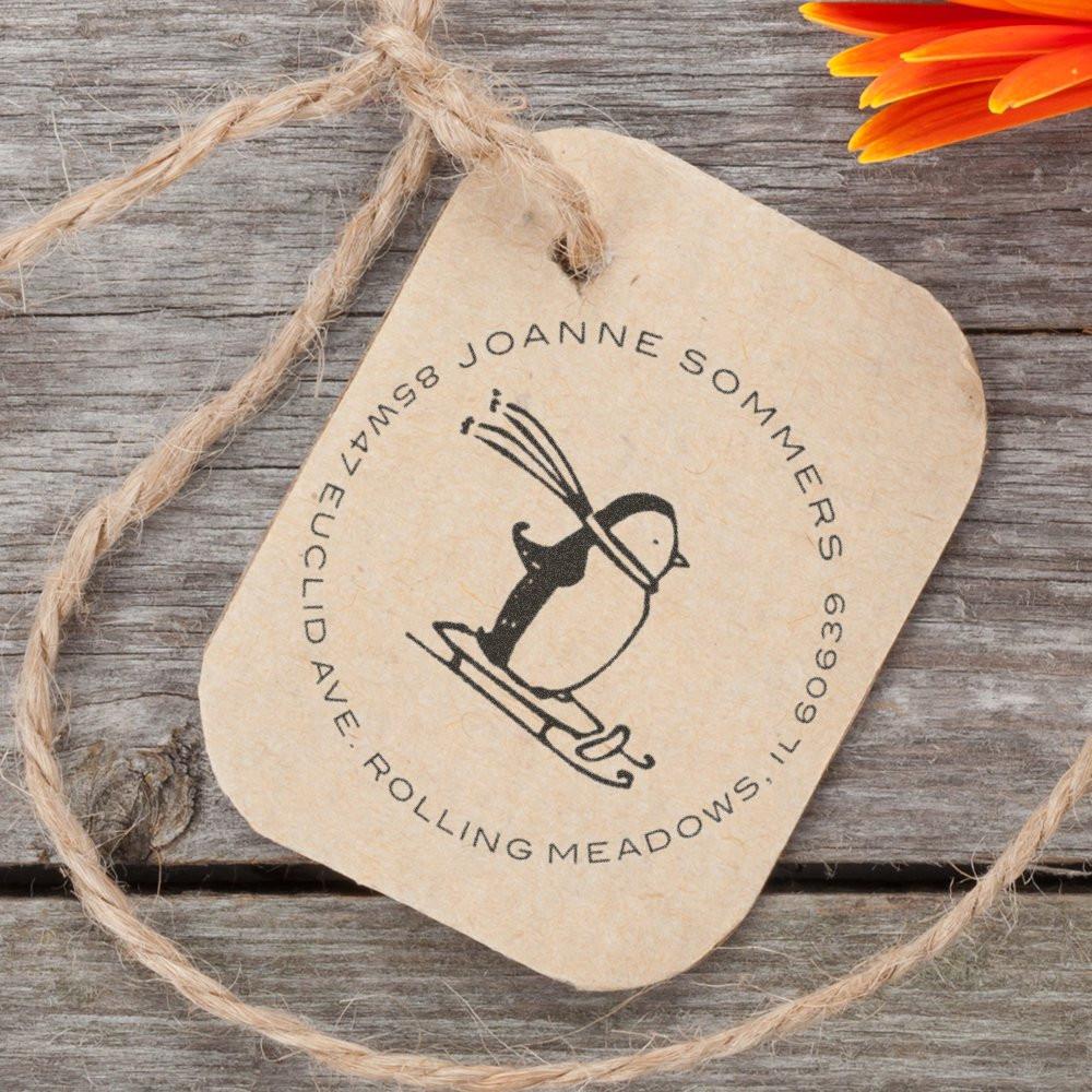 Custom address rubber stamp with penguin design for personalized mailing labels and stationery.