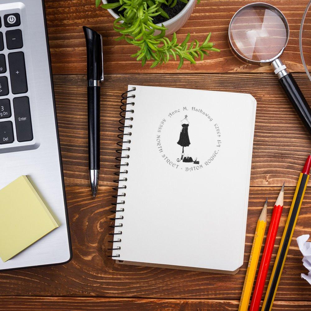 Custom rubber stamp impression on a notebook, showcasing a personalized address stamp for branding and stationery.