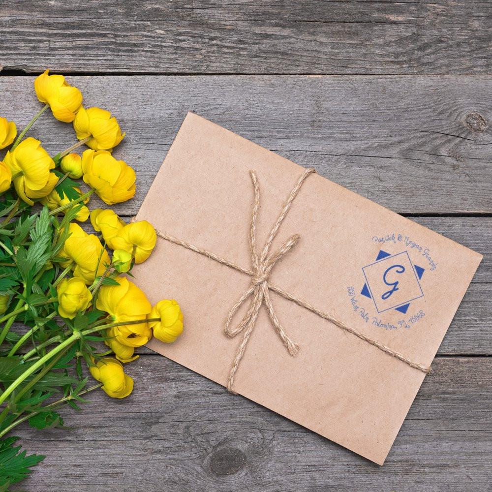 Custom rubber stamp on kraft paper gift packaging with twine, perfect for branded stationery and small business packaging.