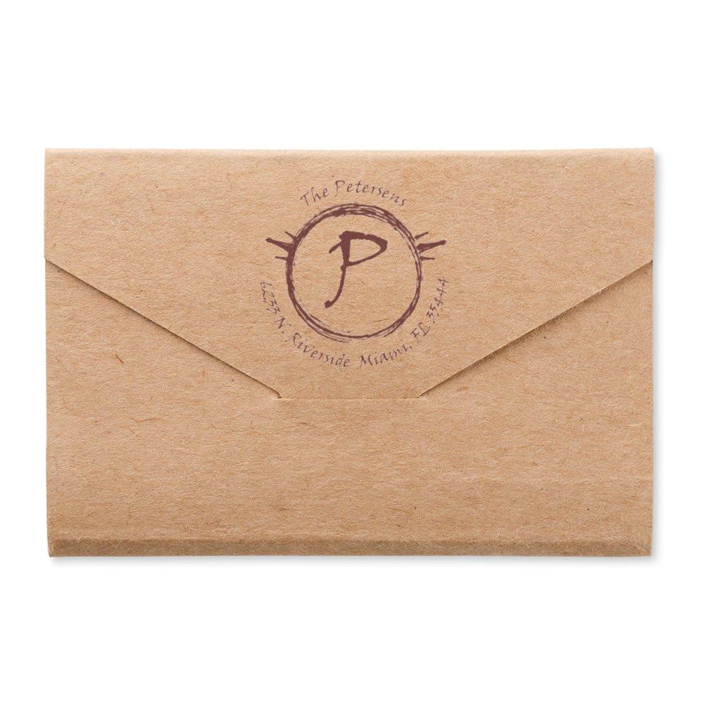 Kraft paper envelope with circular Petersens monogram seal and P logo, representing branded personalized mail for The Petersens.