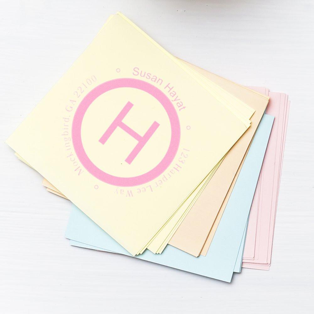 Stack of pastel notebooks and planners featuring a pink circular H logo and the name Susan Hayat on the cover.