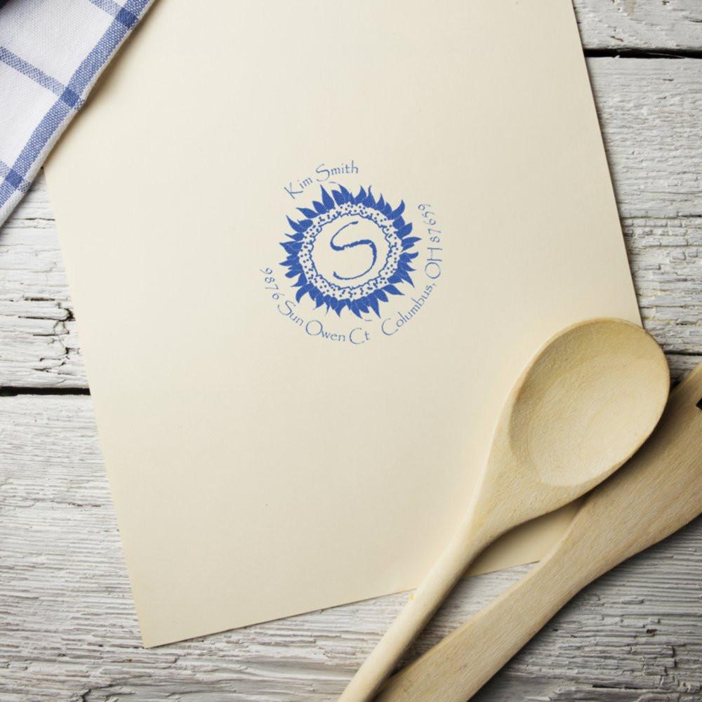 Custom return address rubber stamp with sunflower monogram on envelope, perfect for personalized wedding stationery.