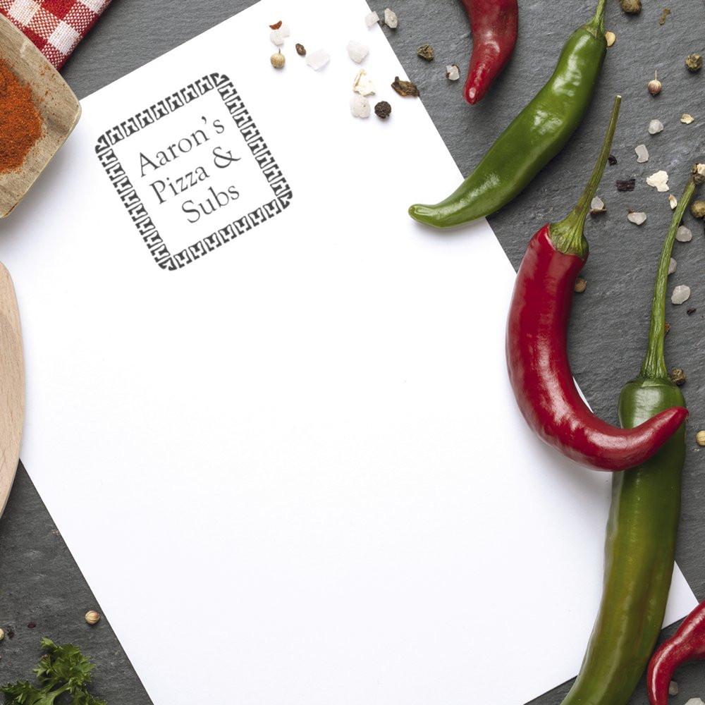 Custom rubber stamp imprint of Aaron's Pizza & Subs logo on paper, ideal for pizza restaurant branding and packaging.