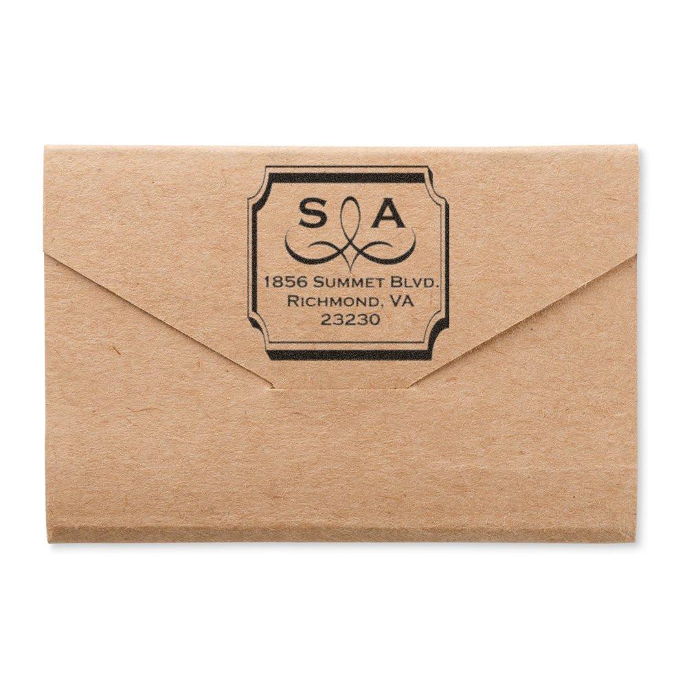 Custom rubber stamp on kraft envelope with monogram and return address, ideal for wedding invitations, business mail, or branding.