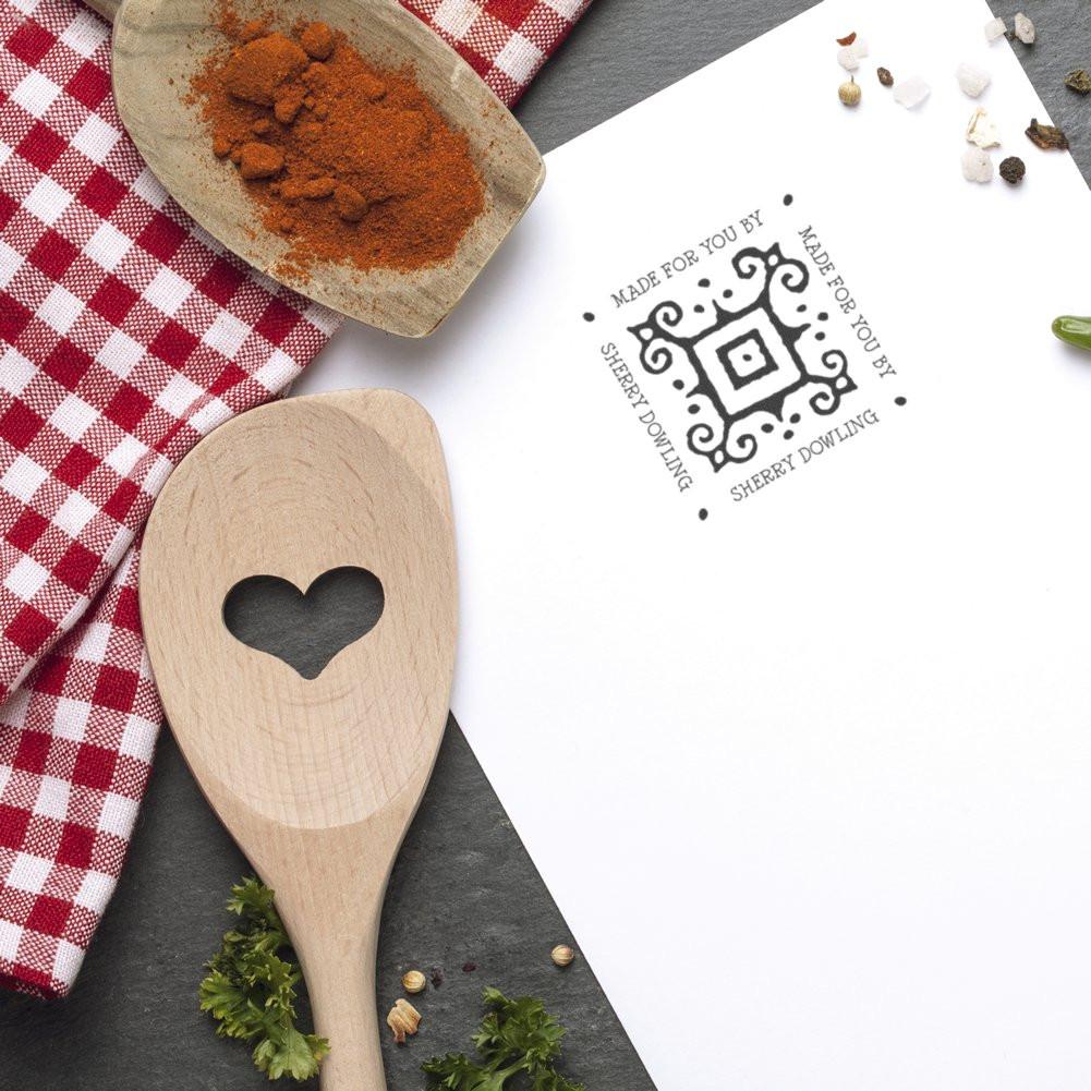 Custom rubber stamp impression reading Made for You by Sherry Dowling on paper, styled with kitchen utensils and spices