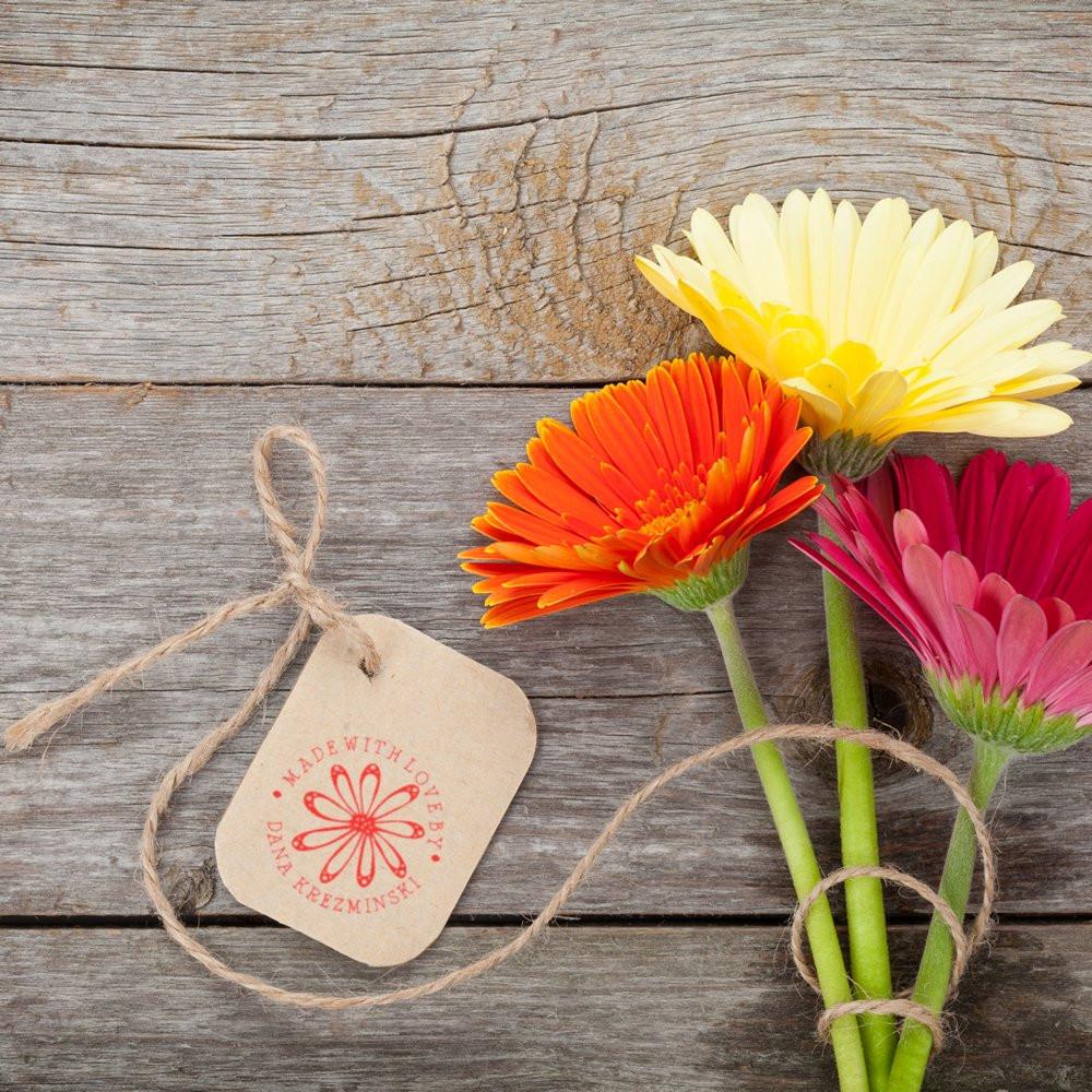 Custom rubber stamp on kraft gift tag with flowers, featuring a handmade Made with Love label.