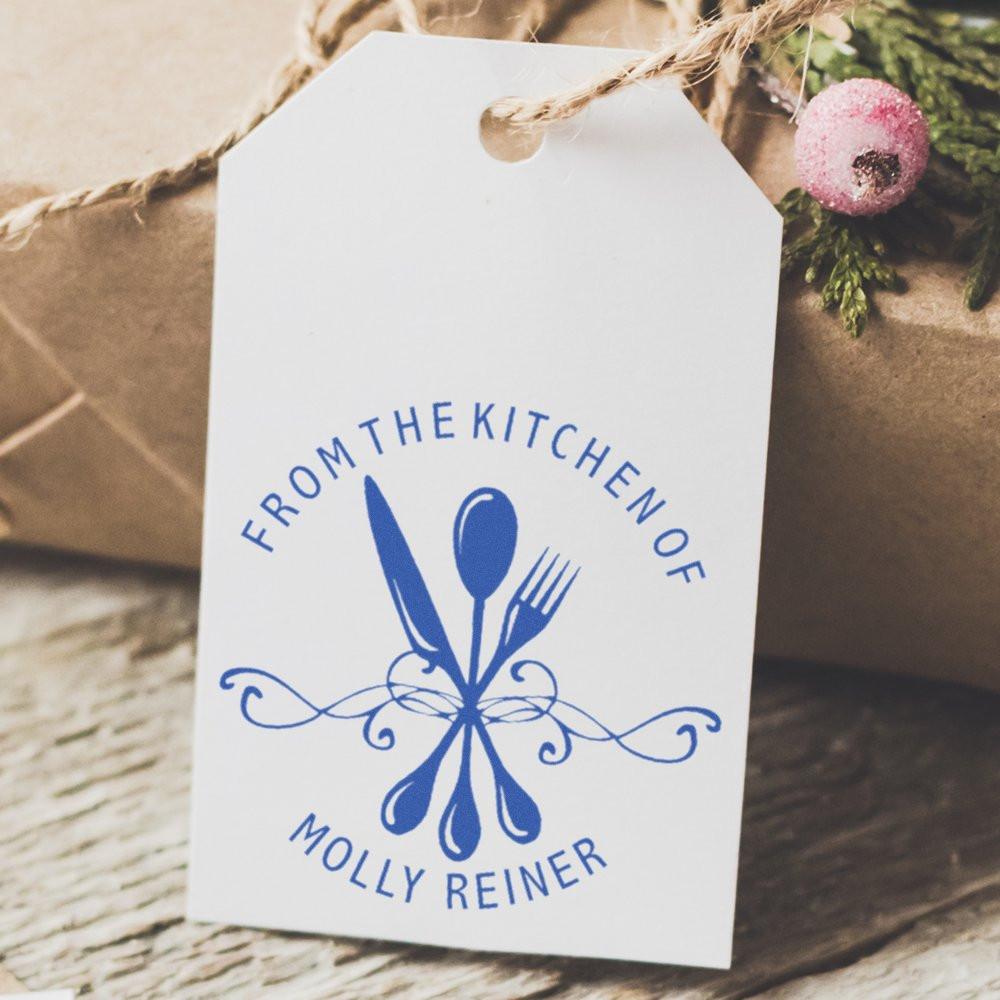 Personalized kitchen rubber stamp on gift tag reading From the Kitchen of Molly Reiner for homemade food gifts.