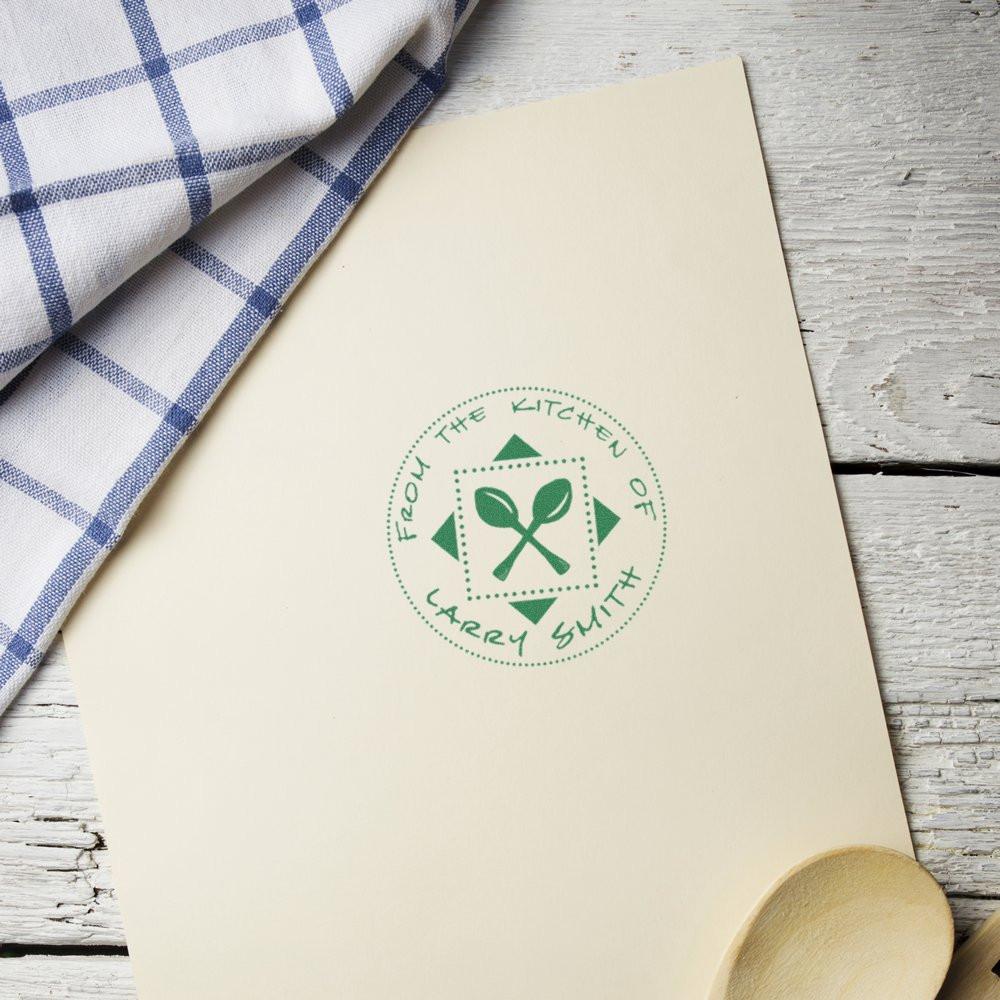 Personalized kitchen rubber stamp on recipe card, featuring From the Kitchen of Larry Smith and a spoon icon.