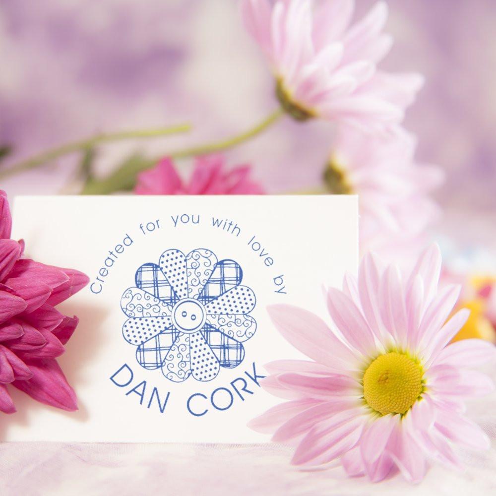 Custom rubber stamp impression reading Created for you with love by Dan Cork on a floral card surrounded by pink daisies.
