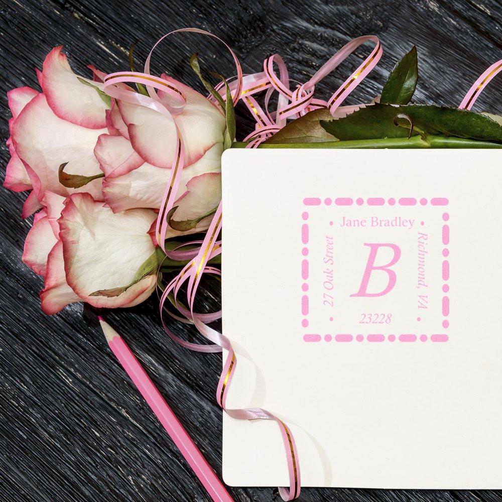 Personalized monogram rubber stamp on wedding invitation with roses, ideal for return address stationery.