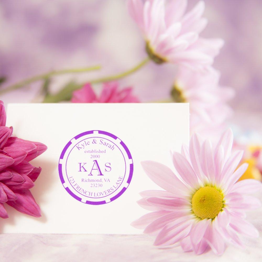 Custom monogram rubber stamp for personalized wedding stationery and return address use with floral styling.