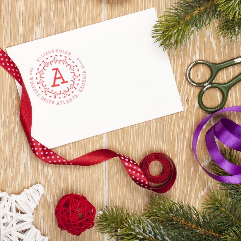 Custom return address rubber stamp on white envelope, styled for holiday gift wrapping, stationery, and personalized mail.