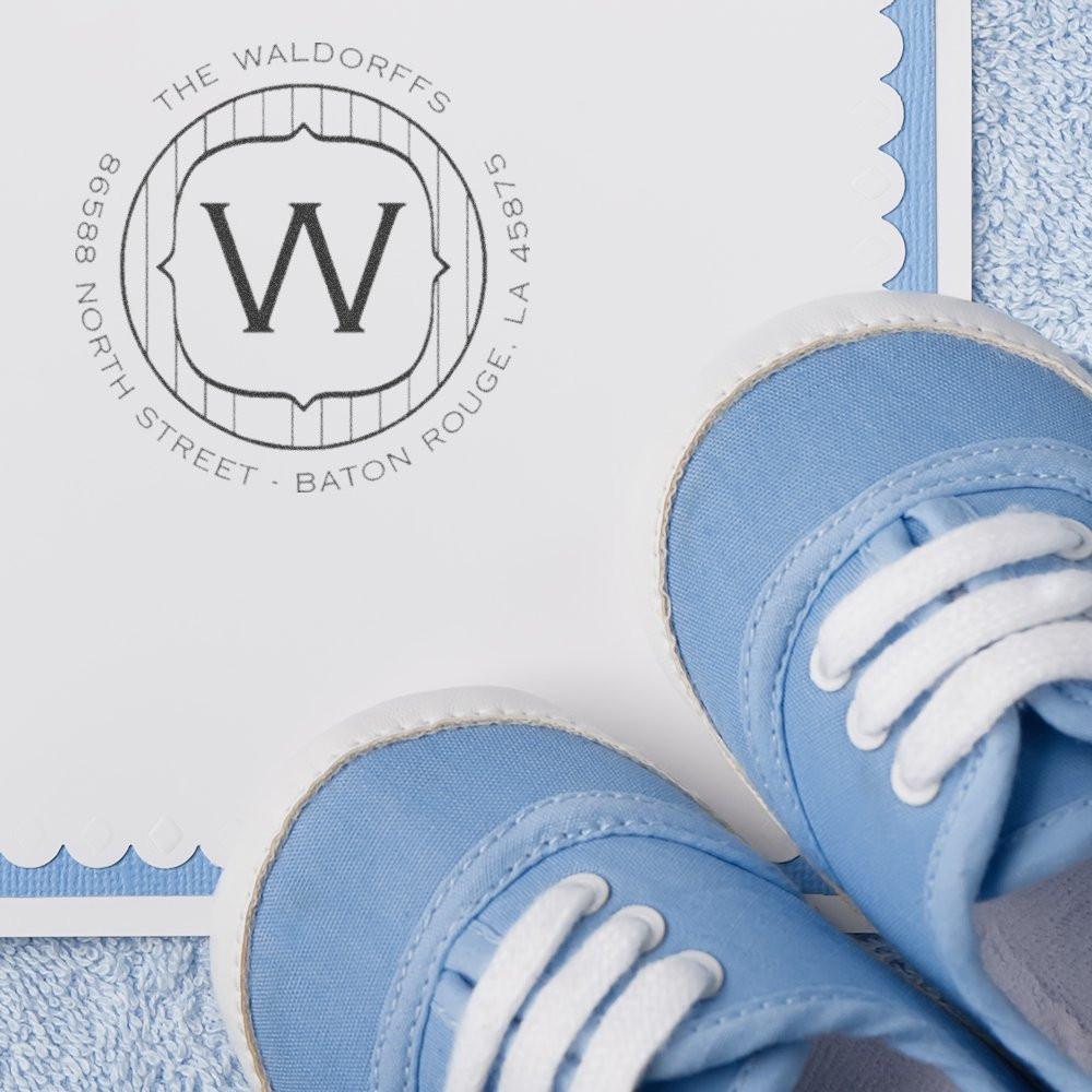 Custom monogram rubber stamp with W imprint on baby announcement card, ideal for personalized stationery branding.