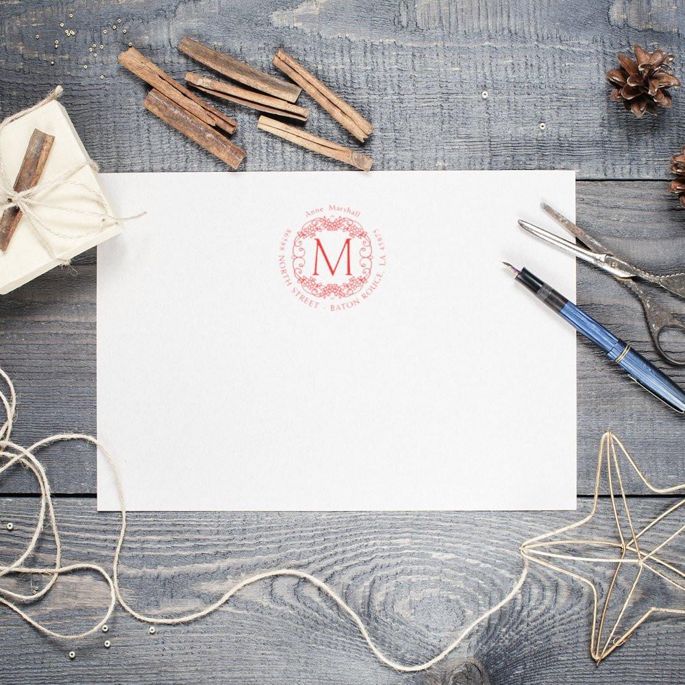 Custom monogram return address rubber stamp for wedding invitations, shown on white stationery for elegant envelope branding.