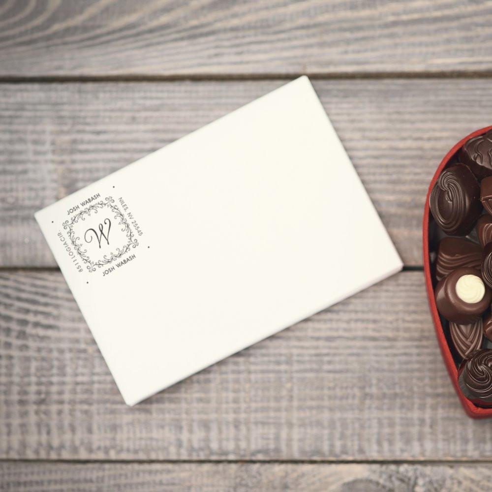 Personalized monogram rubber stamp on a wedding invitation envelope, creating elegant custom stationery.
