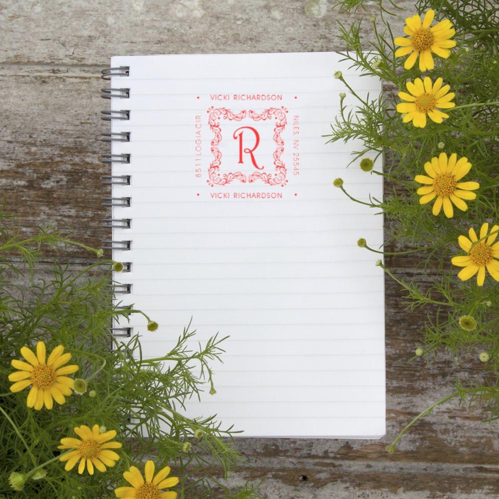 Custom monogram return address rubber stamp featuring Vicki Richardson with floral initial R on a spiral notebook.