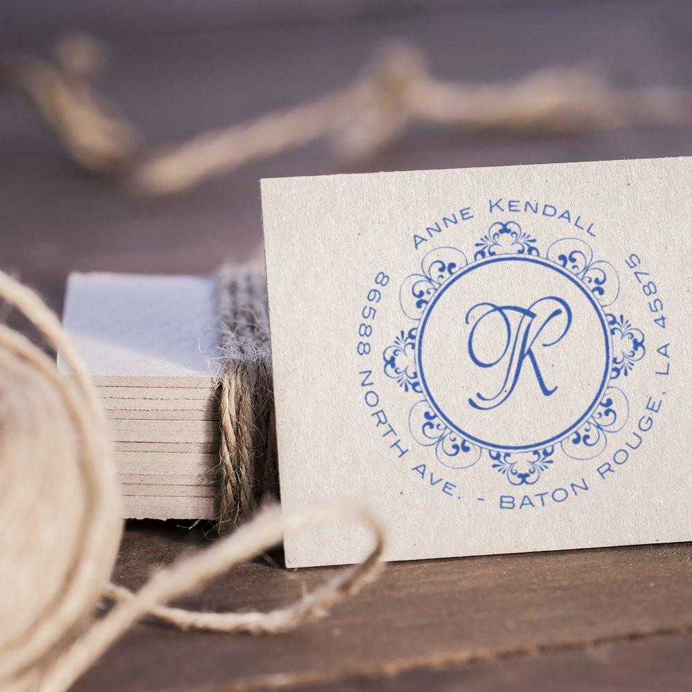 Custom monogram rubber stamp sample in blue ink on cardstock for personalized stationery