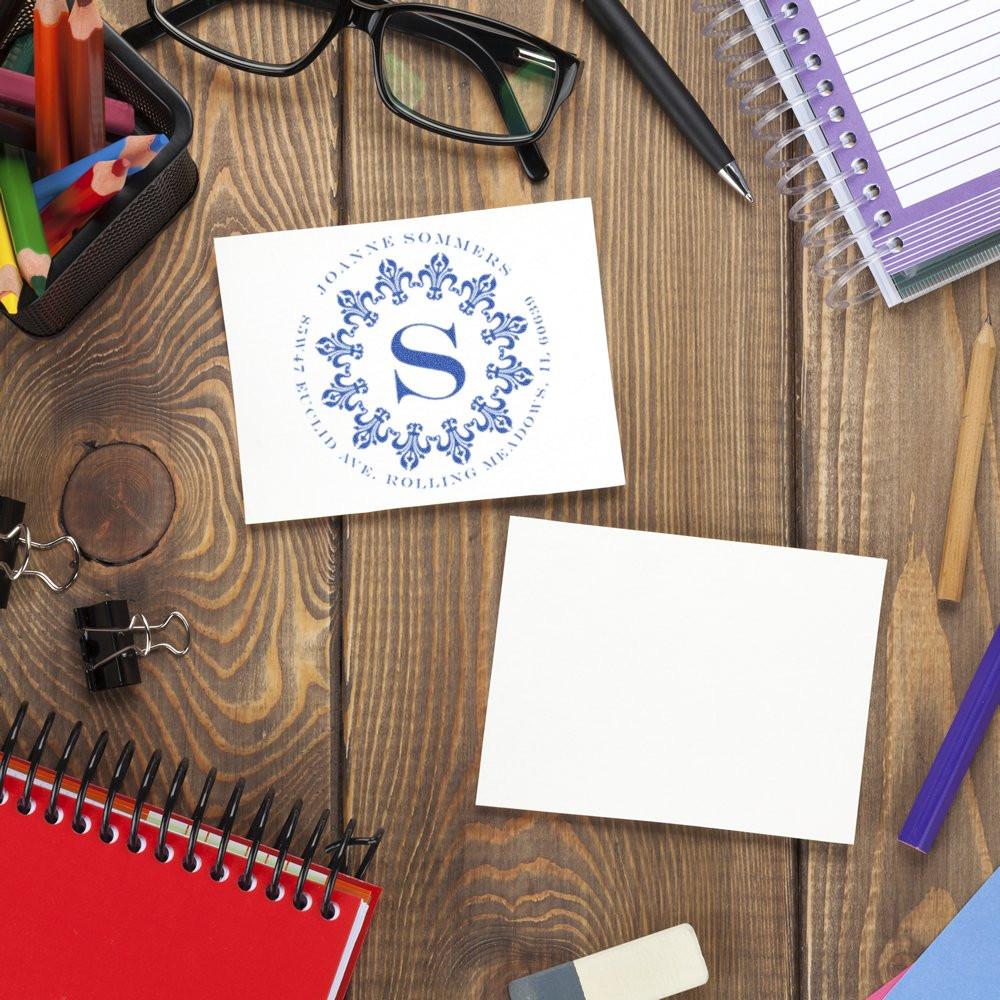 Personalized rubber stamp monogram on paper with stationery, ideal for custom business branding and office organization.