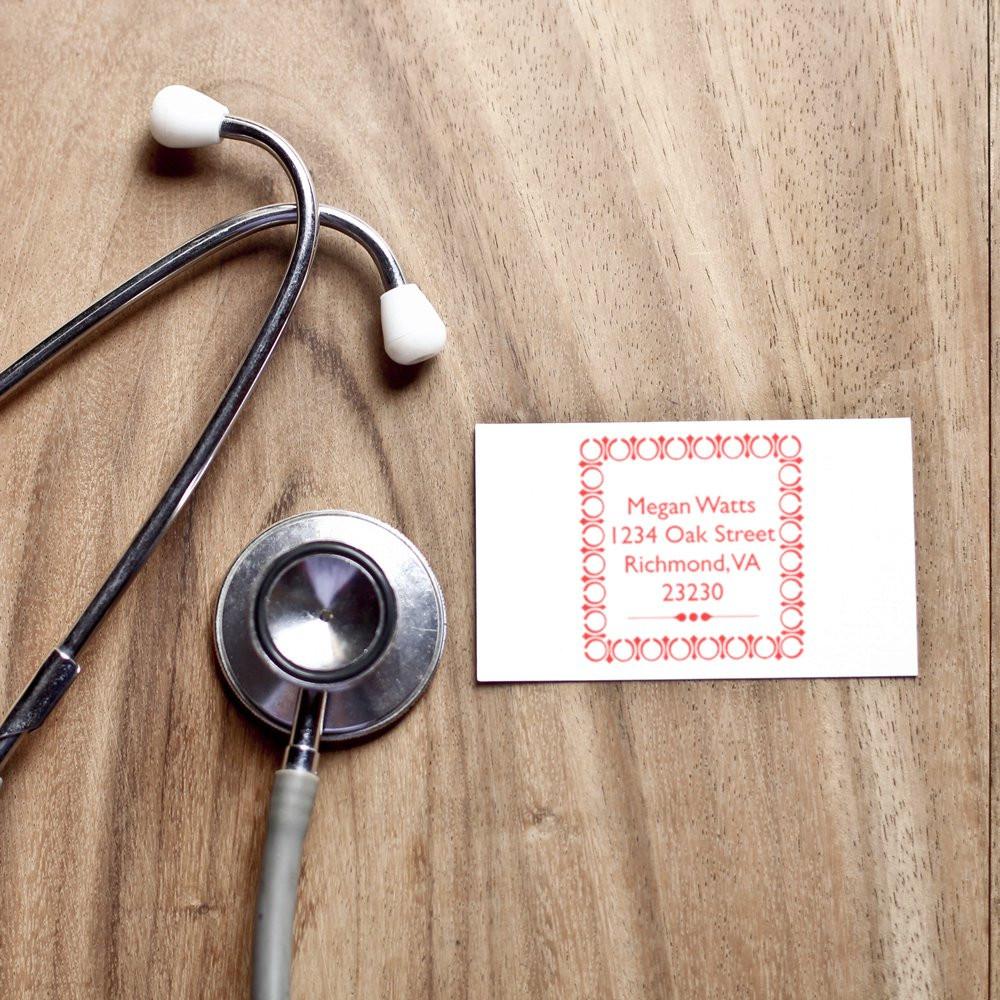 Custom rubber address stamp for a medical office, shown with a stethoscope and sample return address card.