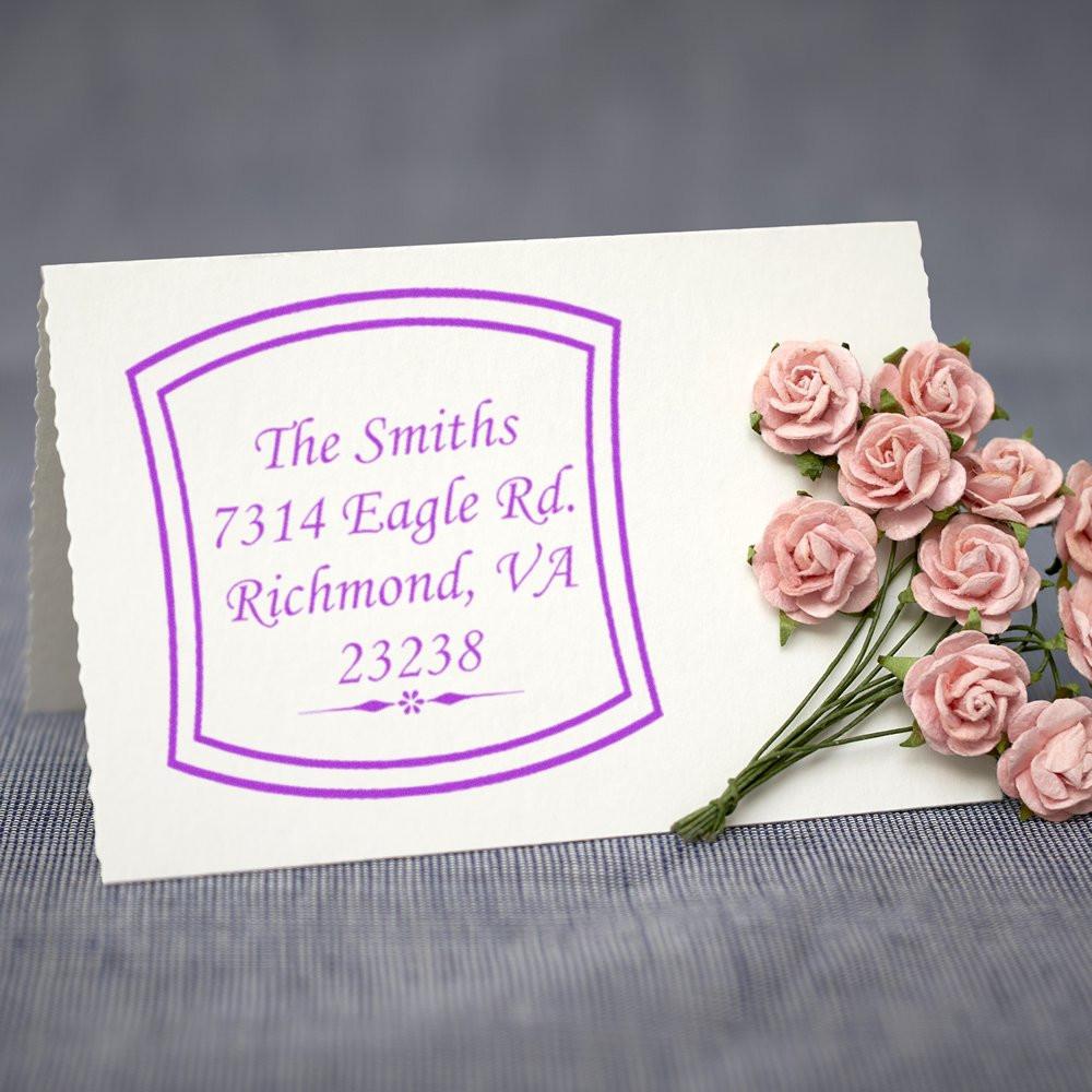 Personalized return address rubber stamp in purple ink, displayed on a card with flowers for wedding invitations and mail.
