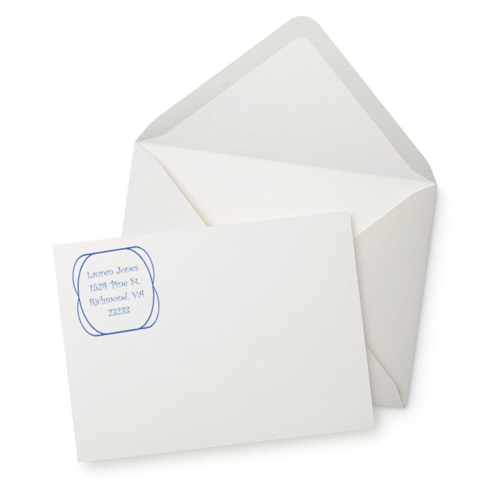 Custom return address rubber stamp on envelope and letter for personalized mailing and business stationery.