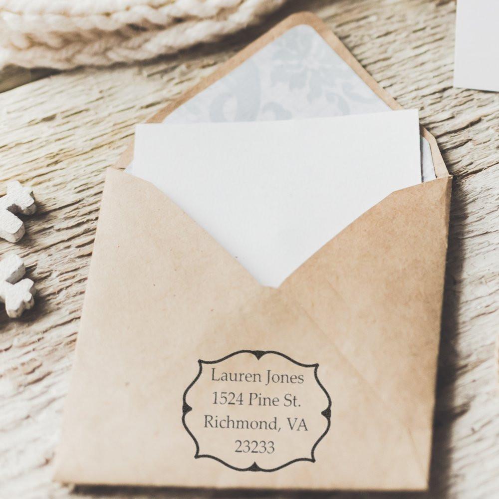 Personalized return address rubber stamp on kraft envelope for wedding invitations and stationery, custom mailing label design