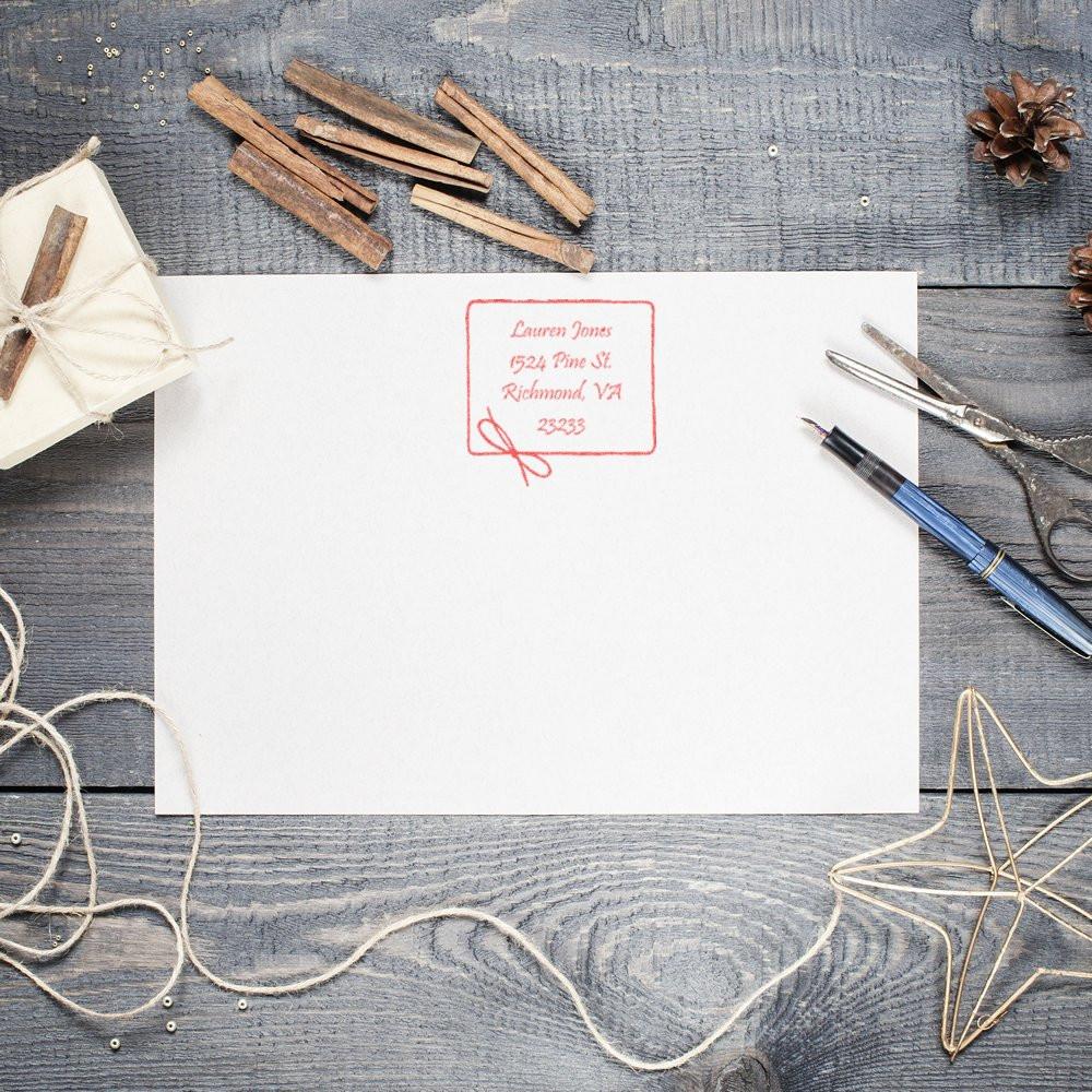 Custom address rubber stamp on envelope for personalized wedding invitations and small business mailing.