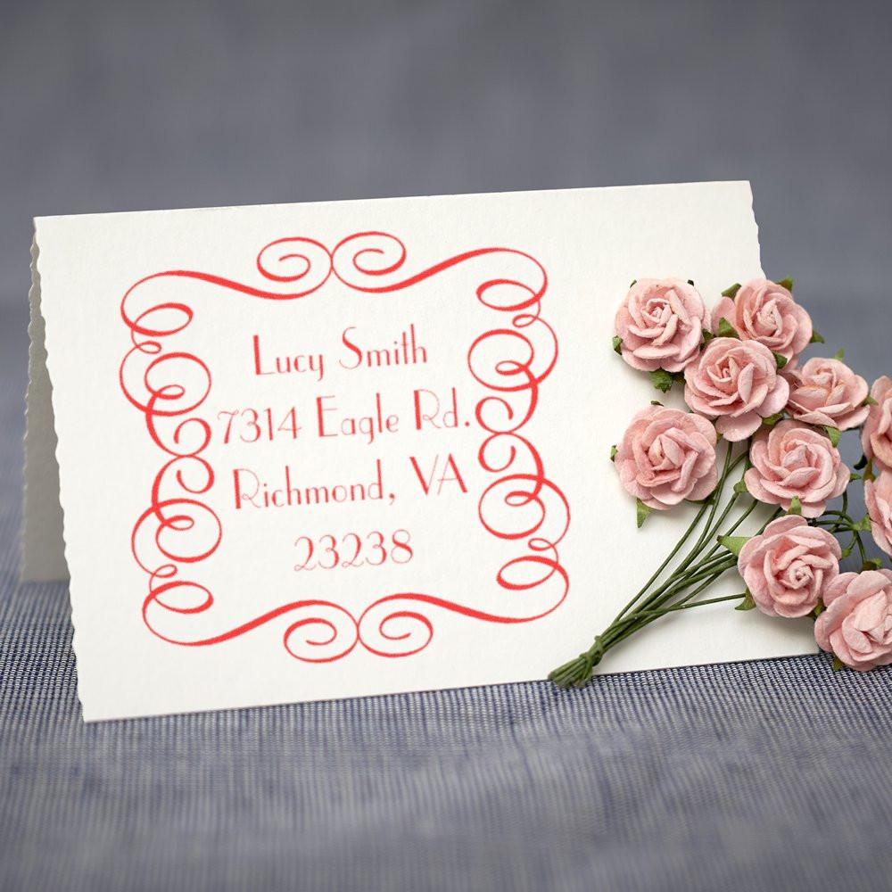Custom return address rubber stamp with decorative border, showing a personalized address stamp on stationery.