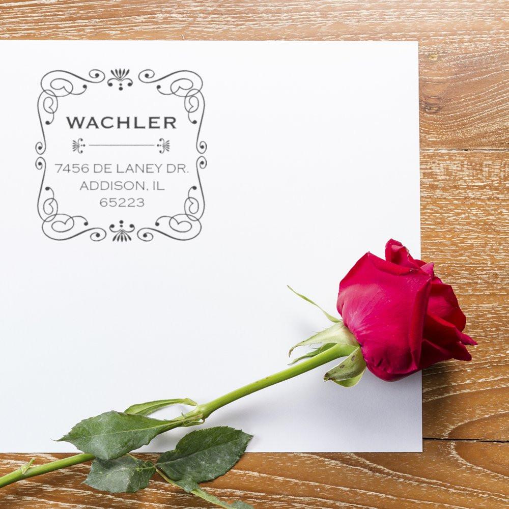 Custom return address rubber stamp with ornate frame, printed on white stationery with Wachler family name and address.