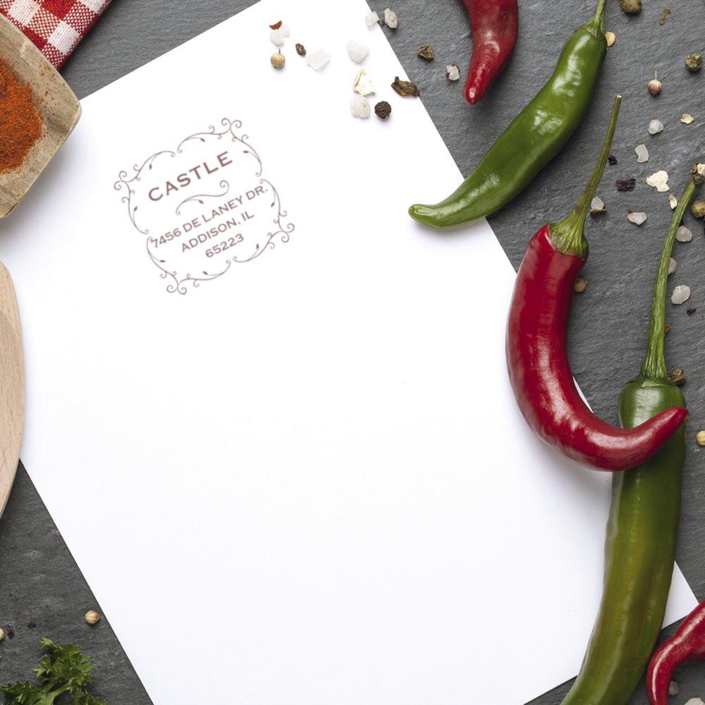 Custom address rubber stamp impression on paper, ideal for personalized branding in a rustic food-themed design scene.