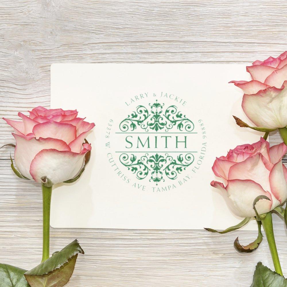 Custom floral monogram rubber stamp with Smith family return address for wedding invitations, styled with pink roses.