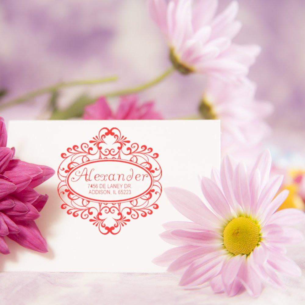 Elegant custom floral return address rubber stamp for Alexander with script name and address.