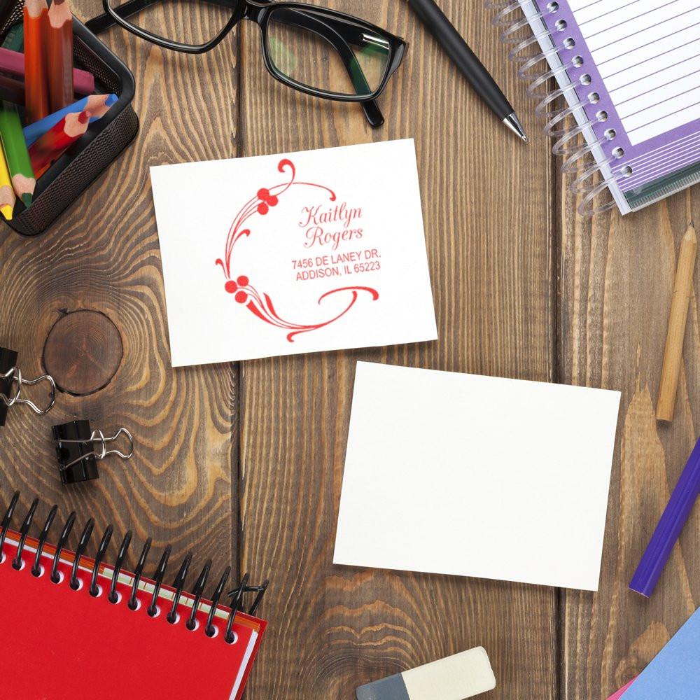 Custom return address rubber stamp impression with floral design, showing personalized mailing details for envelopes and stationery.