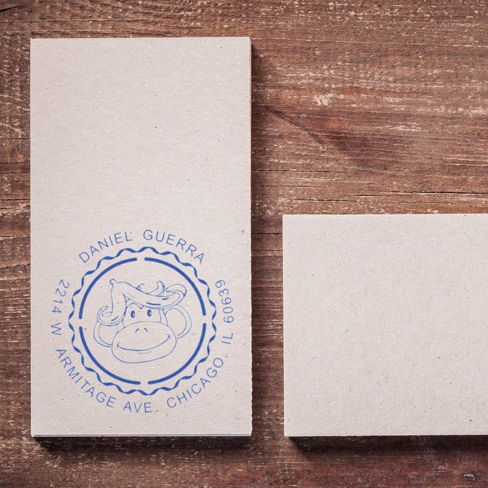 Custom rubber stamp impression with monkey logo and Chicago address, showcasing personalized business branding on paper.